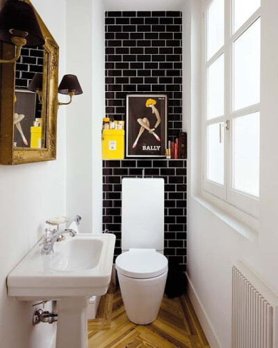 Tiny powder room with black Subway Tile and white grout