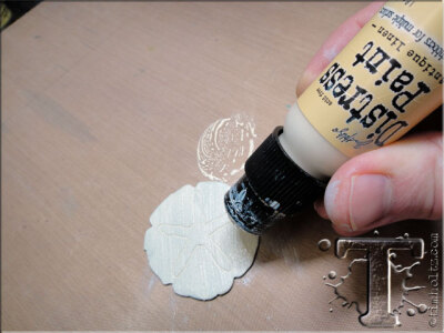 step 8: apply distress paint to one sand dollar to create a wet layer of paint.