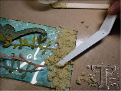 step 43: using a palette knife, spread the sand mixture on to the tag.