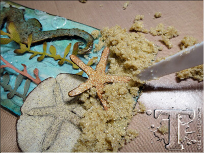 step 45: using the palette knife to add finishing texture to the sand and set it aside to dry completely. *note: keep in mind some of the sand will fall off or become too brittle when dry, however yo…