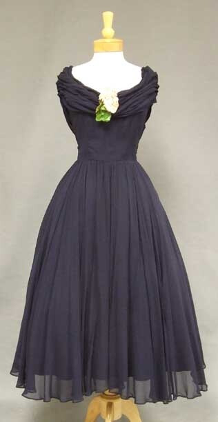 Beautiful navy blue,1950's cocktail dress. Fitted bodice with beautifully gathered and draped neckline. Lovely, sweeping skirt.