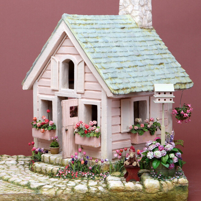 The Pink Playhouse, by Polly Morris, 1996. Construction secrets: structure and landscaping all made from foam core, mat board &amp;amp; card stock. Joint compound was used to good effect to create slate roof, wooden siding, stone fireplace &amp;amp; chimney, cobb