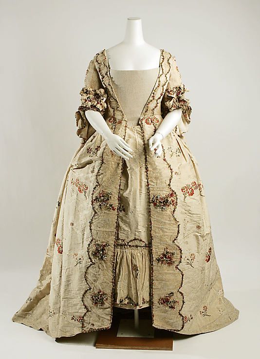 Fashion 18th century ball gown dress Robe a la Francaise circa from 1760-1780. Made from silk with flower floral bouquet pattern in various colours and fabric gather as flounce decorated with lace, trim, ribbon, on the matching stomacher bodice, sleeve and also on the skirt and the petticoat.