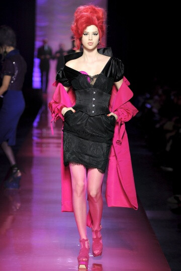 Jean Paul Gaultier SS2012 Couture。Gaultier 成功地将他的高级时装发布变成了Amy Winehouse的欢送会，并为他美丽而怪异的服装增添了色彩艳丽的一笔。并且Gaultier 设计的用披肩包住一边的细条纹西装夹克、珠饰细腿裤上搭颓废的缎面罩衣或者紧身灰色丝质大衣（翻开时露出粉红色的珠片衬里）成功维护了JPG高级时装精神。