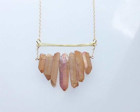 the Crystal Bar Necklace, now with gorgeous peach quartz crystals! Hand hammered brass bars and seven titanium plated quartz crystals ranging from .5 - 1.5 inches long. Crystals will look very much like the ones pictured, though each crystal is unique.Long shiny brass chain, 36 inches.All items shi