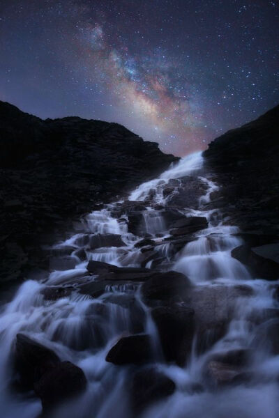 Stars Fall by Roberto Bertero. Gorgeous long exposure photography of the Milky Way over a mountain cascade.