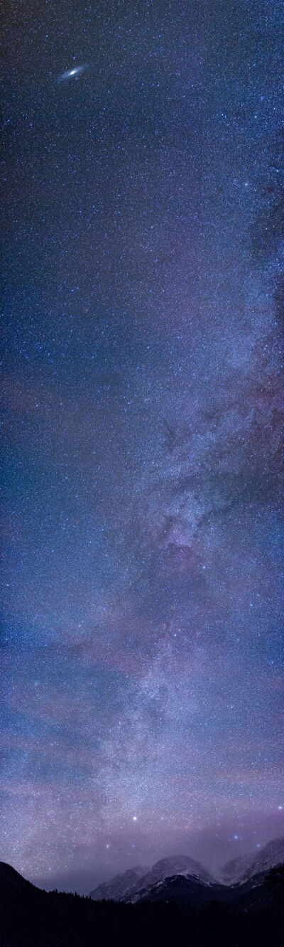 Galaxies light up the night sky in amazing cosmic vista Can you spot the Milky Way and its closest neighbor, Andromeda, in this stunning vertical panorama?