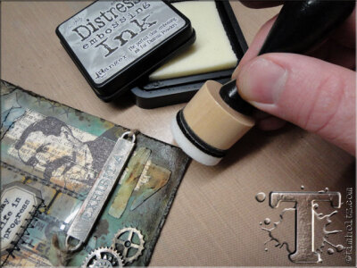 step 24: using a clean mini blending foam, lightly dab distress embossing ink to various corners and areas of the tag.