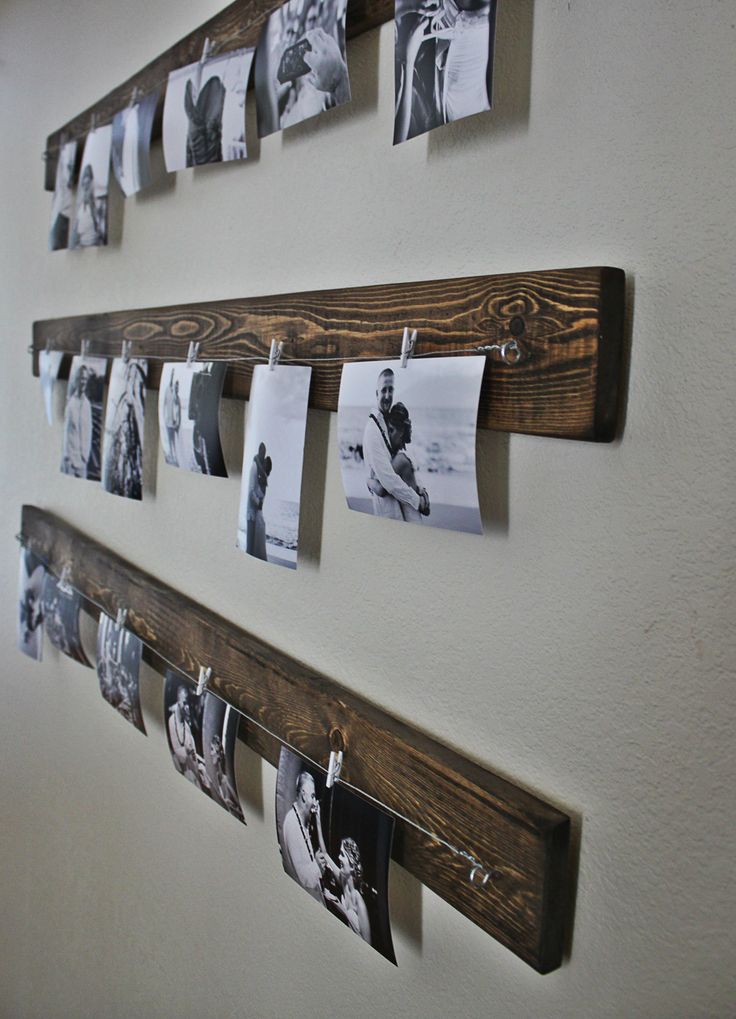 Rustic wall picture display - you can get the line and clips at Ikea in a whole set. Love the wood behind.
