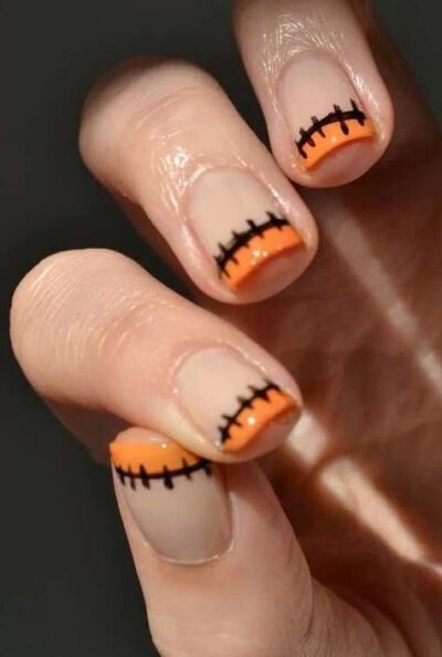 A cute spooky spin on the classic French manicure.