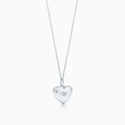 Heart locket in sterling silver with diamonds on a chain.