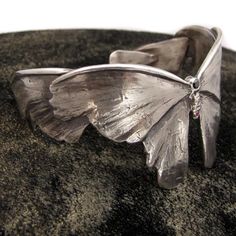 Jewelry artist Nancy Edwards designs accessories that highlight some of nature’s less-loved critters. Here, the Atlas Moth, the largest of the species, is turned into an oxidized sterling silver cuff, adorned with a black diamond, a white diamond and a ruby. $450fab $645 retail price