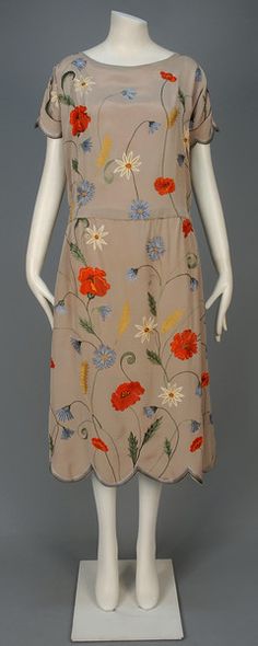 1920-1924 TAMBOUR EMBROIDERED SILK DRESS: Taupe silk with scalloped short sleeve and hem decorated with polychrome scrolling floral embroidery, chiffon lining.