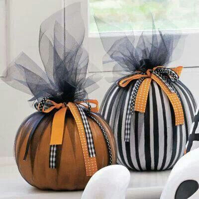 Halloween decor doesn't have to always be creepy. We love the clean looks of these decorated pumpkins.