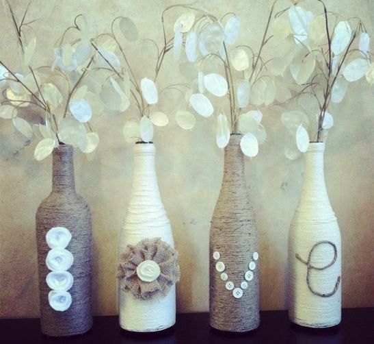 Home decor ideas on a budget: Upcycling - wrap old wine bottles in twine and yarn. Decorate with applique and buttons. ADORABLE