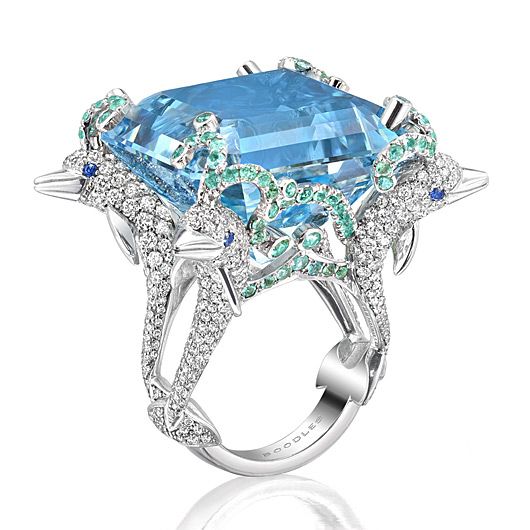 Dolphin A rare Santa Maria aquamarine with the colour and depth of the bluest of oceans is surrounded by dolphins surfing on waves of Paraiba tourmalines. Charming 18ct white gold diamond dusted dolphins look playfully through royal blue sapphire eyes while carrying this special gemstone.