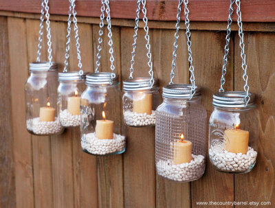 Mason jars make great candle holders because they are able to withstand a lot of heat. Plus simple jars add a rustic touch to the decor. You can use them as simple candle holders or turn them into ga…