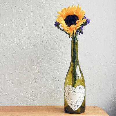 Wine Bottle Centerpiece Such an easy DIY project, and yet, so pretty! Spruce up a wine bottle with a doily to turn it into an interesting centerpiece.