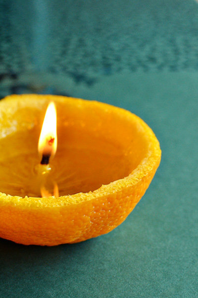 Orange Candle Slice an orange in half and dig out everything except the stem-like piece in the middle, which will act as the wick. Fill it up with olive oil, and light the wick. The flame is supposed …