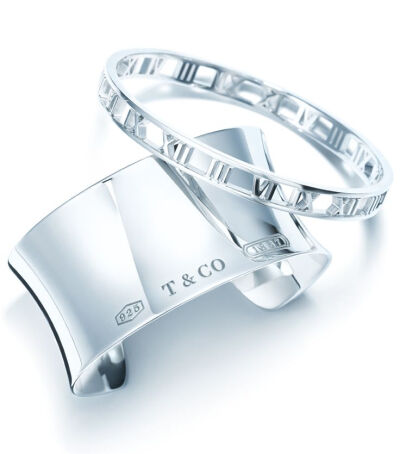 An Atlas® bangle and a Tiffany 1837™ cuff in sterling silver. #TiffanyPinterest #silverbracelets #romannumerals