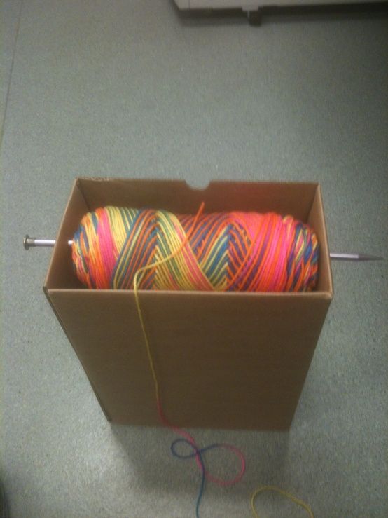 Ingenious way to hold your yarn while crocheting. Box, one large knitting needle, and yarn!!.