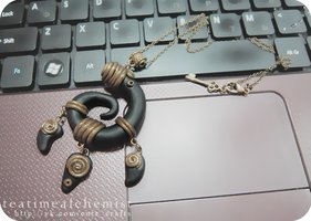 black and bronze clay pendant by tea-time-alchemist