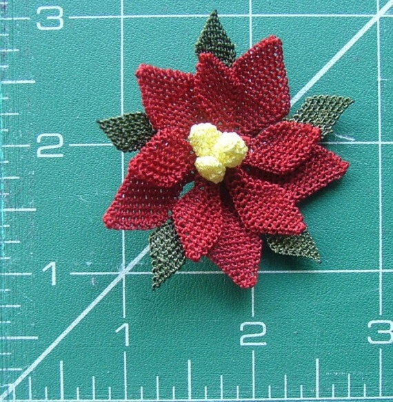 A special application of the traditional oya technique. A real sample of art, handmade poisettia form brooch.