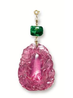 CARVED PINK TOURMALINE, JADEITE AND SEED PEARL PENDANT. The translucent tourmaline of pink colour, carved with a phoenix and peonies, symbolising wealth and luck, suspended from a cord strung with seed pearls and a jadeite bead. Tourmaline approximately 50.76 x 39.16 x 8.72mm.