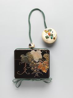 Case (Inrô ) with Design of Grapevine Period: Edo period (1615–1868) Date: 18th–19th century Culture: Japan Medium: Case: gold and colored lacquer and gold foil on black lacquer with greenstained iv…