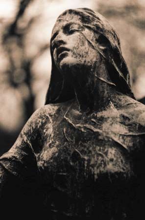 statue in père-lachaise cemetery, paris.