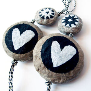 A set of two handmade decoration. The beads are entirely made of recycled paper mache. Handshaped and painted and they're unbreakable! A unique present to give (or to keep for yourself#. The two beads are strung on a black and white striped cotton string. sizes.jpg Sizes: The large bead #with hearts