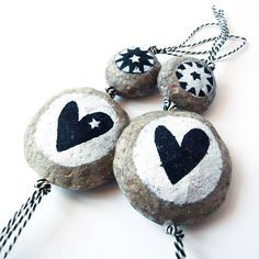 A set of two handmade decoration. The beads are entirely made of recycled paper mache. Handshaped and painted and they're unbreakable! A unique present to give (or to keep for yourself#. The two beads are strung on a black and white striped cotton string. sizes. Sizes: The large bead #with hearts…