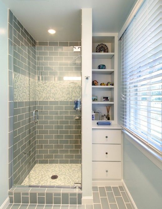 Basement bathroom - shower tile + built in shelving tucked into corner, great for small space