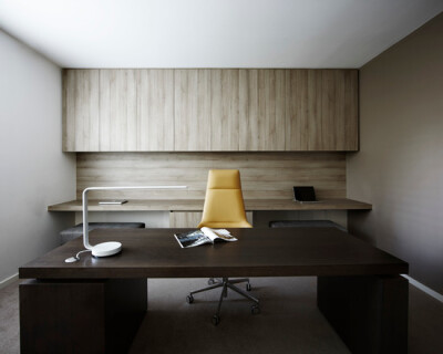 Elegant home study with custom joinery and executive task chair from Arper