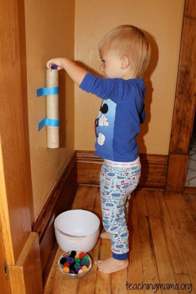 Tape a paper towel roll to the wall to keep toddlers busy.