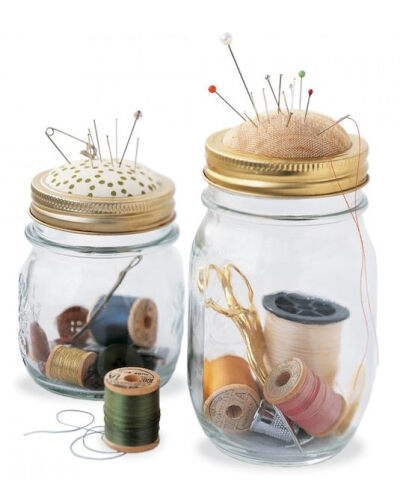 Store all of your small sewing supplies inside of a jar and use the top as a pin cushion.