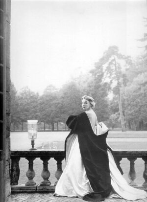 Model wearing a Givenchy gown and cape in a 1952 photo by Henry Clarke for Vogue. ​