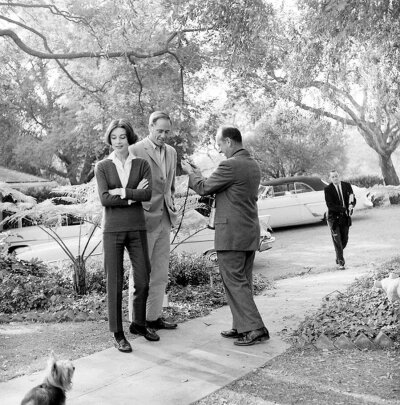 Audrey Hepburn and Mel Ferrer with their pet dog, Famous, outside their home in Los Angeles, CA,1957. ​​​