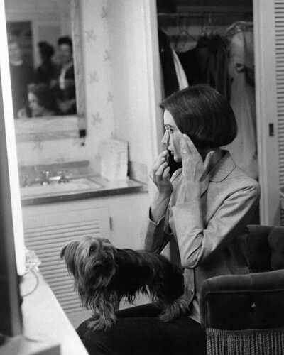 Audrey Hepburn with her pet dog, Famous, in her dressing room at Paramount Studios in Los Angeles, CA, 1957. ​​​