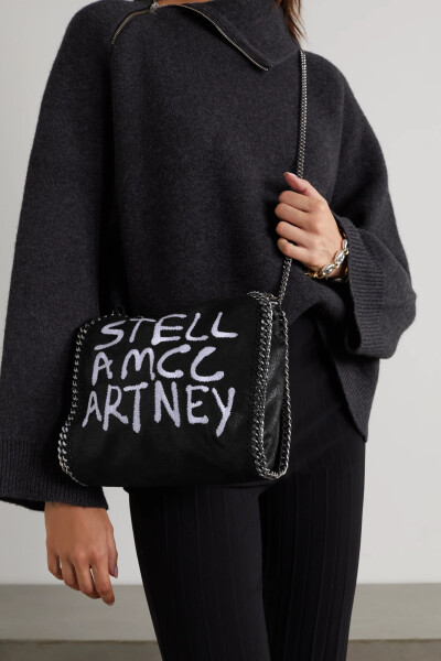 Stella McCartney 这款 “Falabella” 迷你手提包采用植物性磨砂皮革制成，链条和锁缝边饰是品牌的标签式设计，包身绣有由多维艺术家 Ed Curtis 打造的喷漆风标志字母。不妨为它装上肩带，方便斜挎。