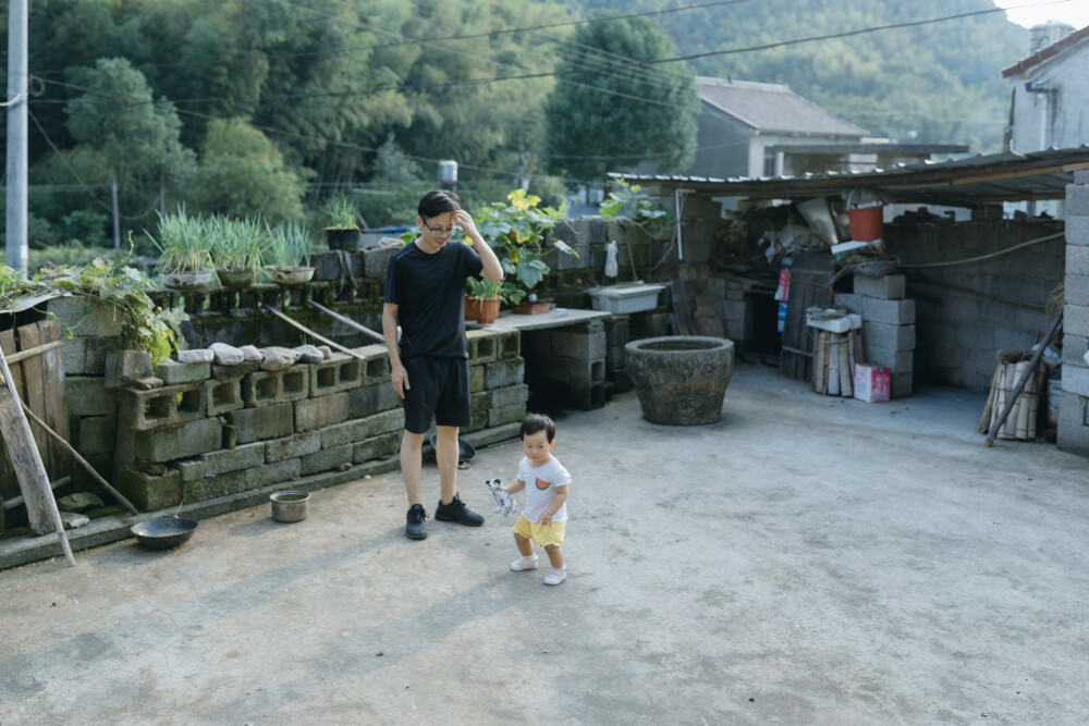 今年中秋在上虞小住
摄影：洪小漩
出镜：家人
连日来，关于上虞的消息不绝于耳。
严峻的疫情防控下，作为中风险地区的上虞，陷入了封城的境地。听阿科说，爷爷奶奶已经去做了两次核酸检测，而其他亲属也都居家隔离。所幸的是，日常蔬菜都实行配给，大家也都做好了不给疫情防控添乱的准备。
在我想象中，疫情对爷爷奶奶的影响应该是很小的。
毕竟，爷爷年逾八旬，奶奶也年近耄耋。两个老人家，久居山林，远离尘世，自在，也寂寞。除了偶尔外出赶集，平日里，鲜少外出。疫情恐怕是造访不了他们的活动区域。
奈何，这次来势汹汹，连两个老人家都曾被半夜唤醒，需乘着夜色赶去做核酸。不过，与他们而言，既然有需要，照做便是。