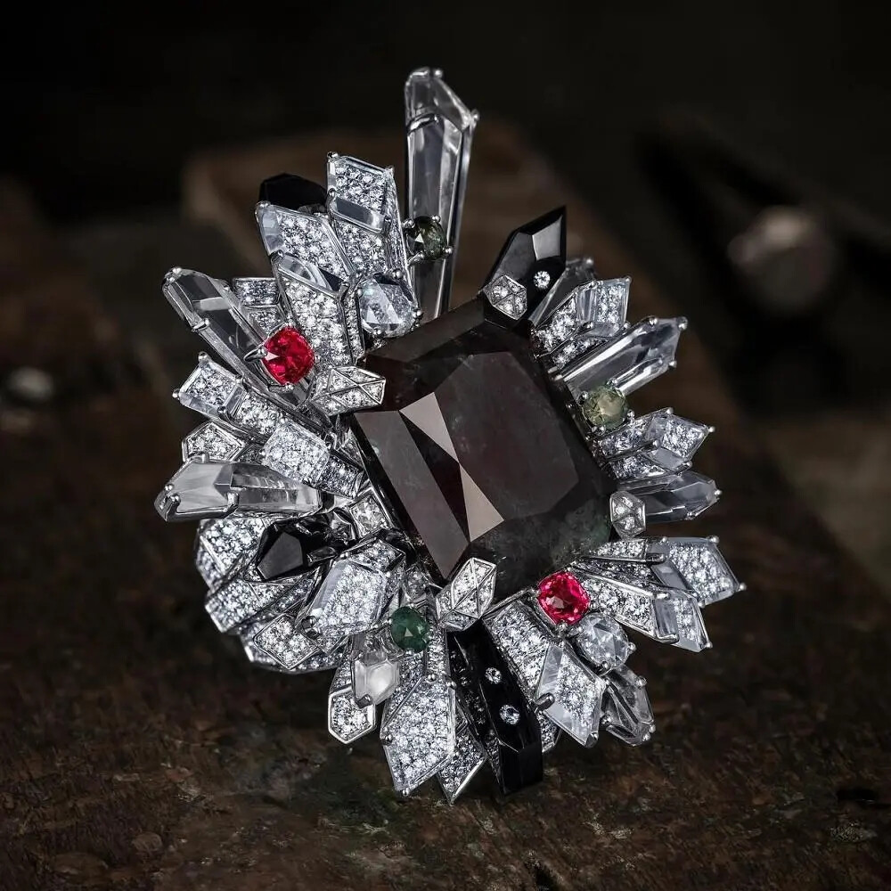 这套 Imperial 白金项链配套的还有一枚戒指和耳环。 戒指主石为一颗29ct的阶梯形切割亚历山大石，同样产自俄罗斯，在不同光线下可呈现出蓝绿色或红紫色调。主石周围镶嵌水晶、镀黑钛金属、粉色尖晶石、黝帘石和钻石，白、黑、红色的晶柱呈放射状， 呈现出的生命张力可以清楚地感知。