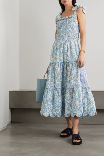 Horror Vacui 的作品往往洋溢着鲜明的浪漫气息。这款 “Isa” 中长连衣裙裁自花卉印花纯棉，上身的皱褶效果为手工完成，层接式裙摆和肩部系带上装点着品牌特色的扇贝边。