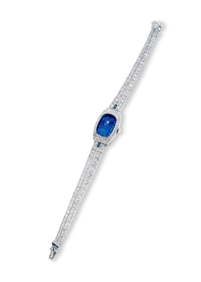 铂金镶嵌缅甸星光蓝宝石蛋面手动上链腕表，边缘围绕钻石，链接钻石表带。