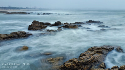 海浪流水时光慢门。时光慢门是一种摄影技术，它通过调整快门速度和光圈大小来捕捉动态场景的静态美。具体来说，时光慢门技术可以让相机在较长时间内保持曝光，从而捕捉到水流、车流等动态物体的流动轨迹，给人一种动…