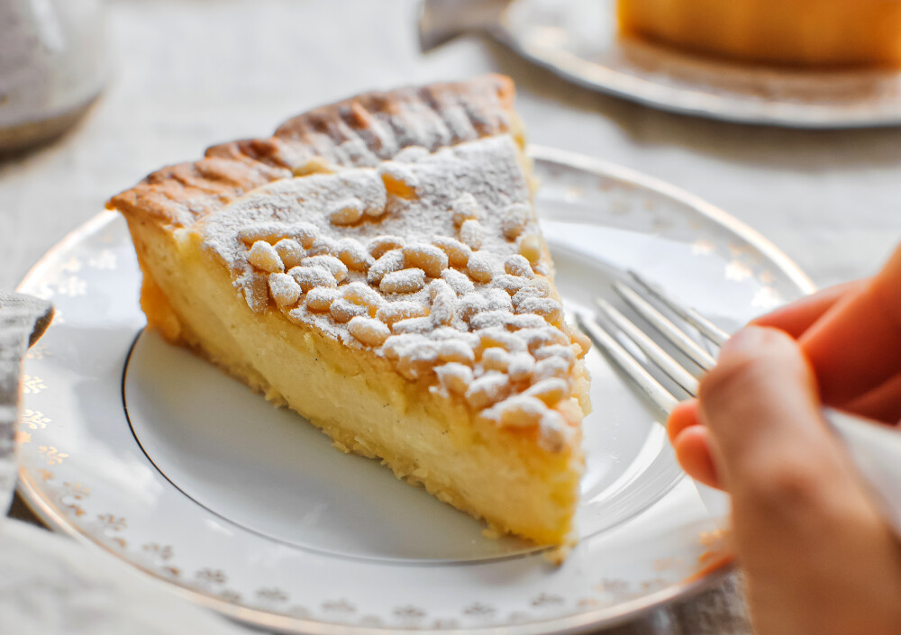 意大利 Torta della Nonna 松仁奶黄塔 祖母蛋糕 来自托斯卡纳大区（Tuscany）的传统甜品。面团的制作不费力，里面通常是浓郁细腻的蛋奶糊（卡仕达酱 crema pasticciera），馅料加入柠檬皮、香草或Ricotta乳清干酪调味，将表面烤得酥脆再撒上糖粉和松子。名称直意即是“祖母做的派”，体现了意大利料理的精髓—家庭风味，沿用由祖母传给母亲的传统制作方法，外表朴素，却涵盖了文艺复兴时期具有里程碑意义的几种糕点制作技术——酥皮糕饼（pasta frolla）、意式基础海绵蛋糕（Pan di Spagna）、蛋奶糊（卡仕达酱 crema pasticciera）