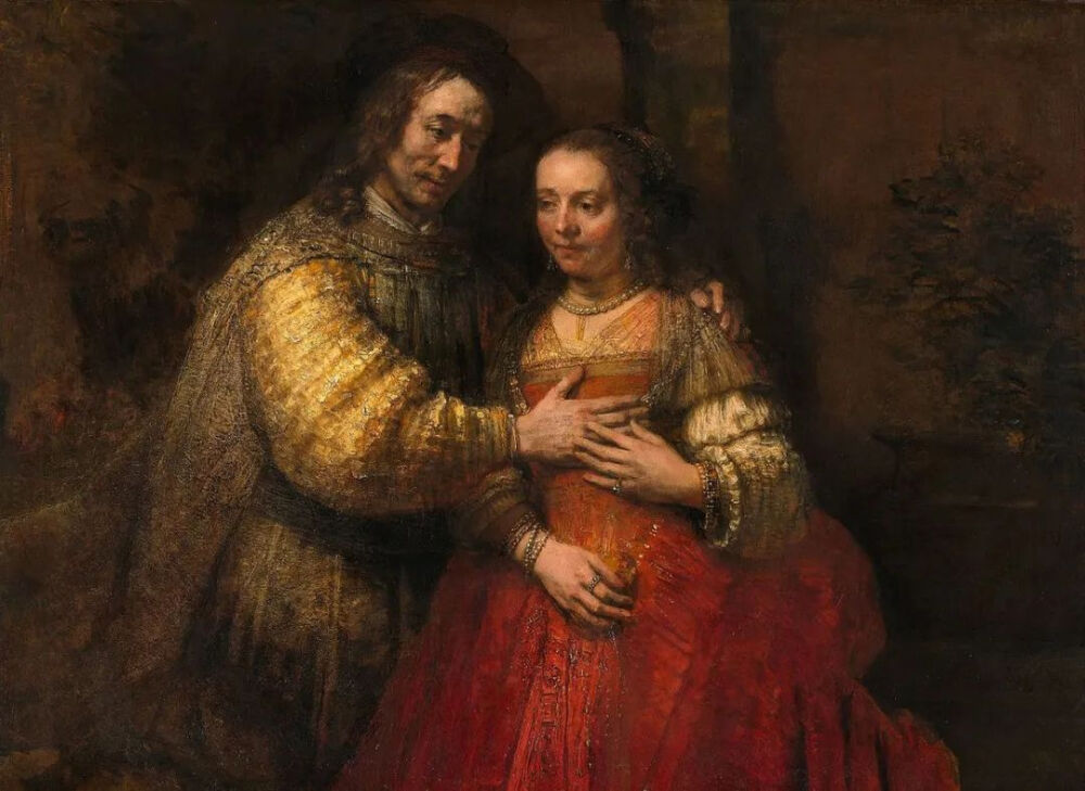 林布兰·哈尔曼松·范·莱因（Rembrandt Harmensz van Rijn）的《艾萨克和丽贝卡夫妇的肖像》（Portrait of a Couple as Isaac and Rebecca，1665），该画又叫作《犹太新娘》（The Jewish Bride）。© wikimedia