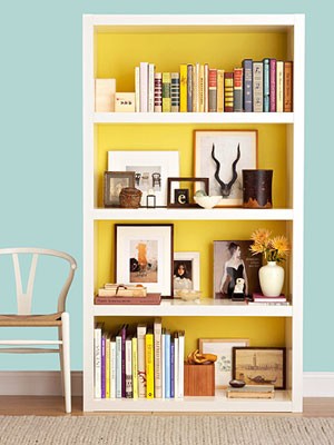 Awesome bookshelf styling. PLUS...paint the shelf back a vibrant color! POP!