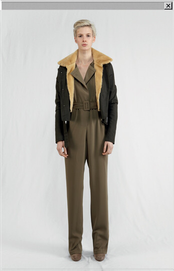 Glazed cotton jacket with metal hook closure and detachable sheepskin waistcoat worn with a fluid jumpsuit with metal hook closure and suede ankle boots.