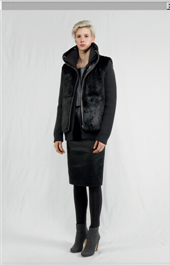 Wool 'camionneur' cardigan with detachable rabbit fur waistcoat worn with leather and knit top, a satin skirt, jersey leggings and ankle boots in rubber tweed leather